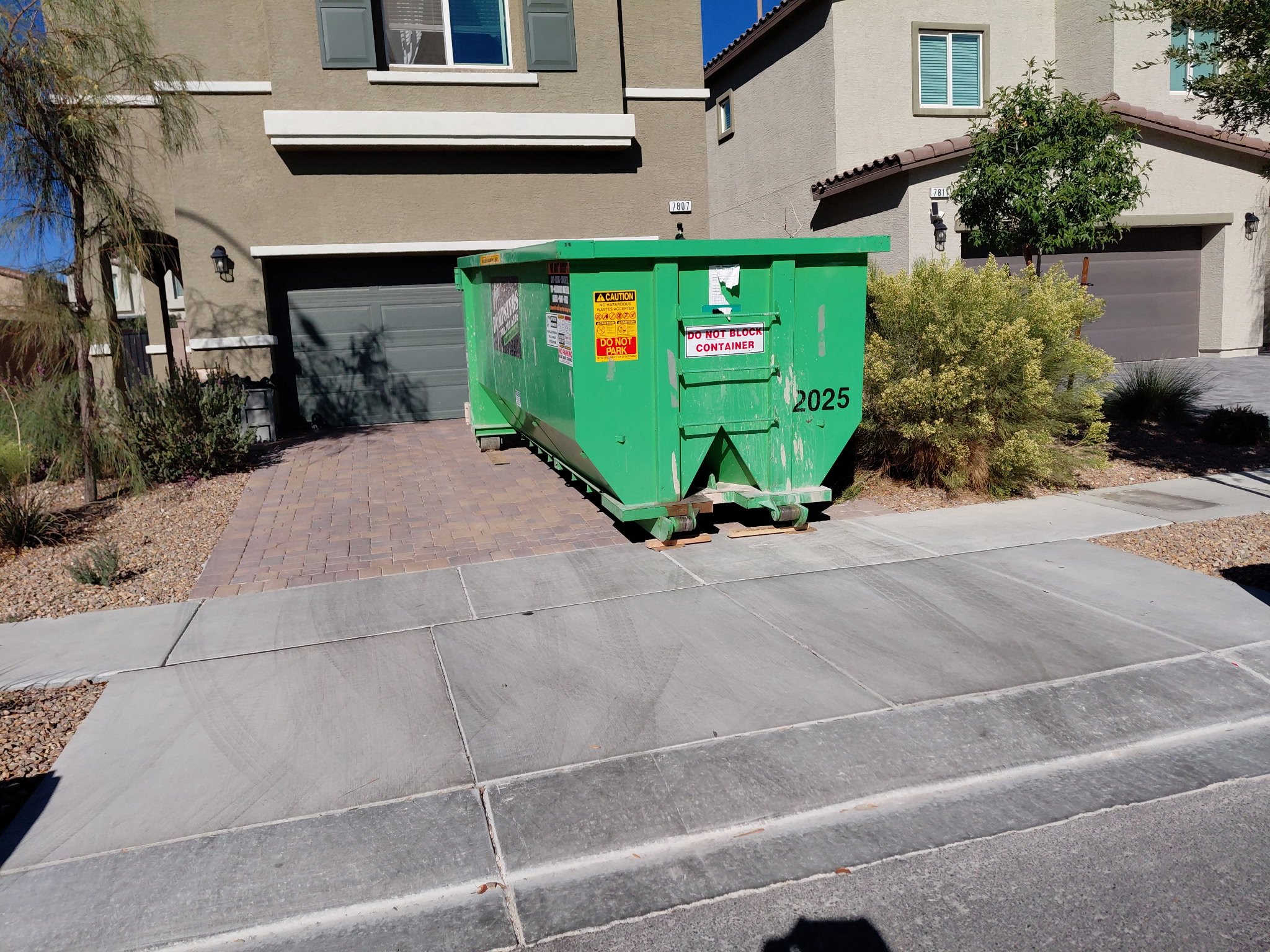 20-Yard dumpster in a driveway for size reference.