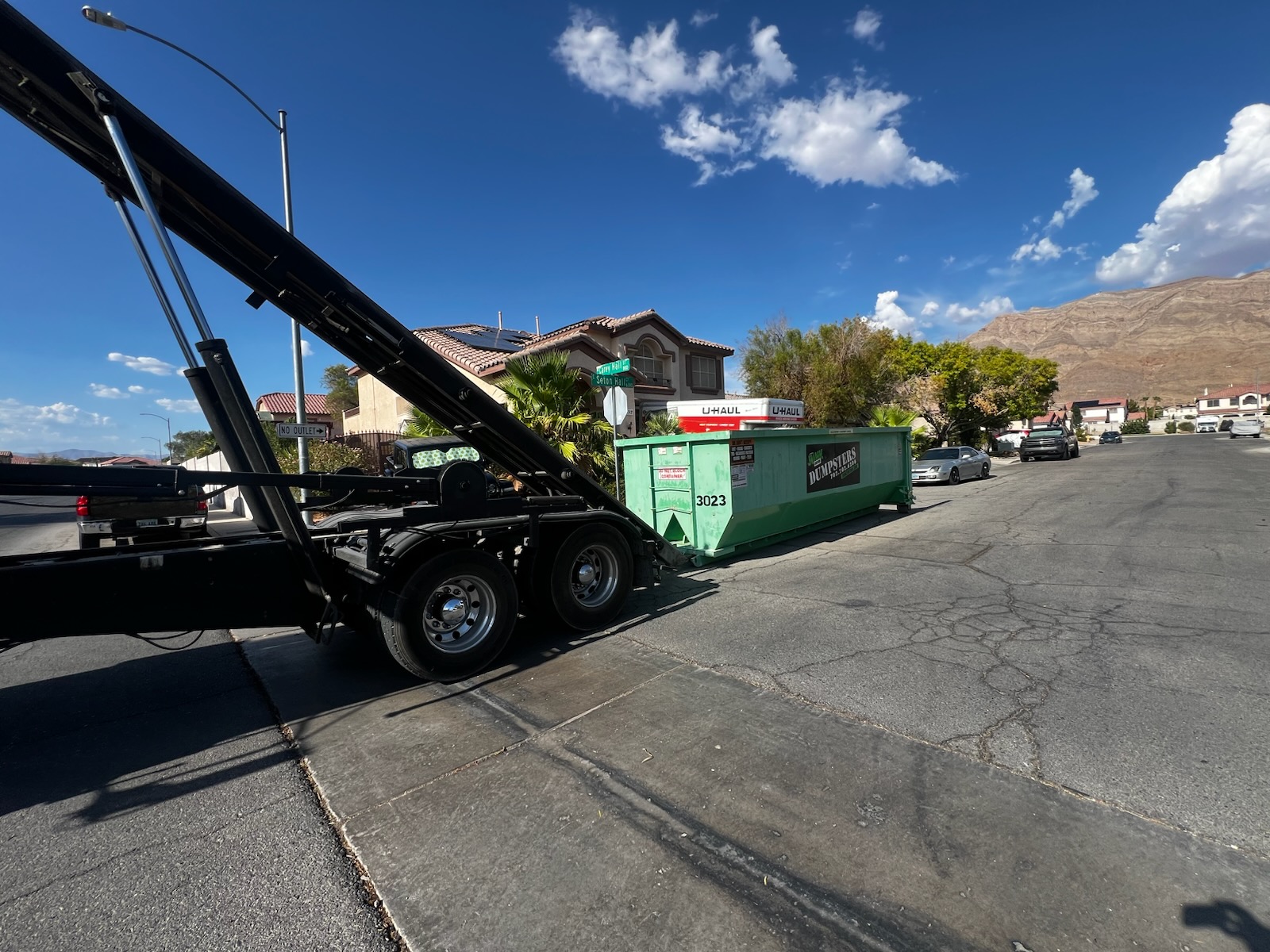 Residential roll-off dumpster in the driveway of a Green Valley, Henderson home during a home renovation and garage cleanout project.