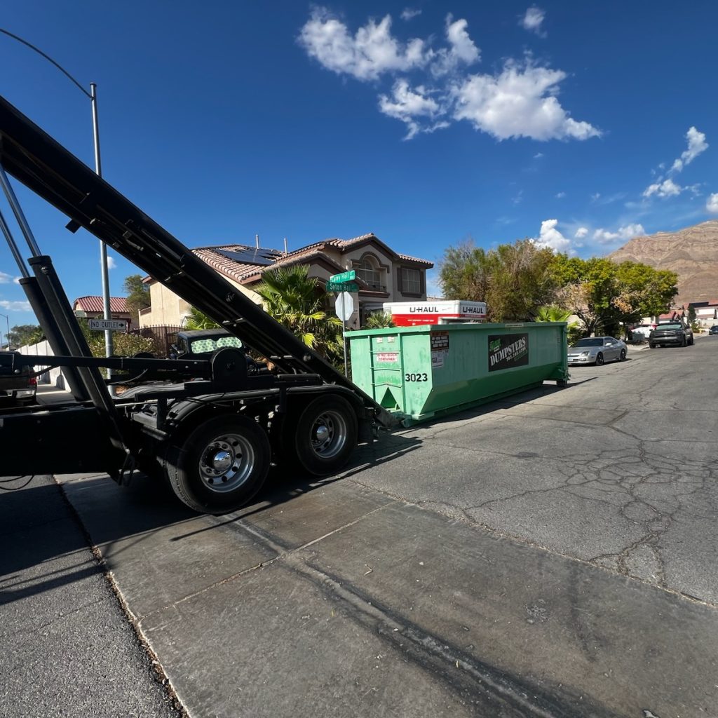 Residential roll-off dumpster in the driveway of a Green Valley, Henderson home during a home renovation and garage cleanout project.